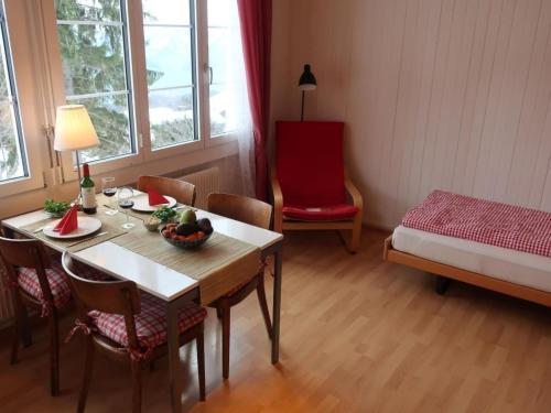 a room with a table and chairs and a bed at Apartment be und mee by Interhome in Rigi Kaltbad