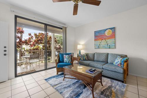 a living room with a couch and a table at Grand Champions 033 in Wailea