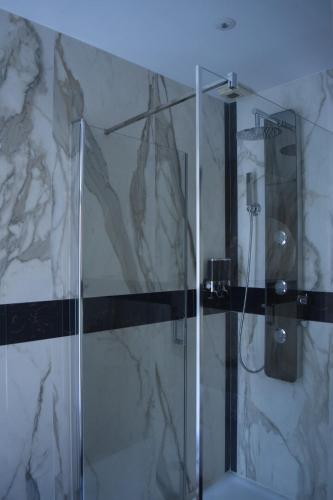 a shower in a bathroom with a glass shower stall at Lit en Loire in Saint-Cyr-sur-Loire