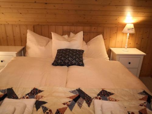 a bed with two pillows on it in a room at Apartment Karotte by Interhome in Trub