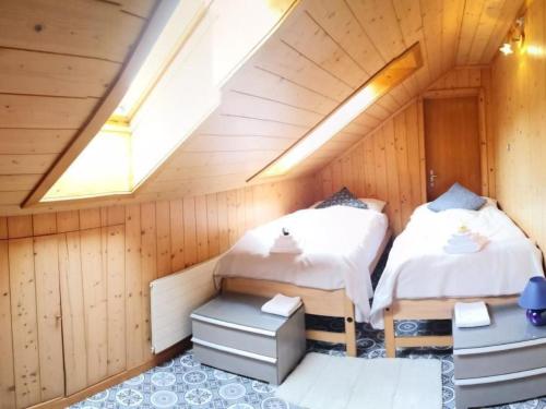 a room with two beds in a attic at Apartment Karotte by Interhome in Trub
