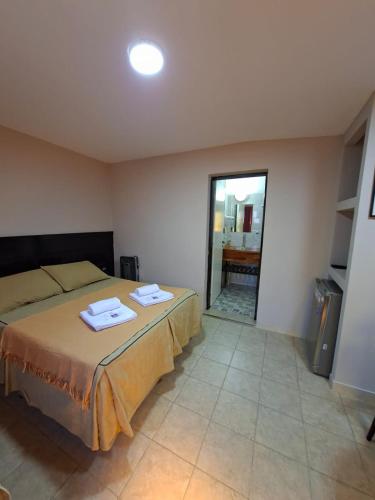 a bedroom with a bed with two towels on it at Hosteria Marina Bella 3 in Rada Tilly