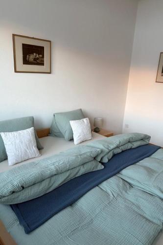 a bed with two pillows on it in a room at Apartment Poste viglia by Interhome in Lohn