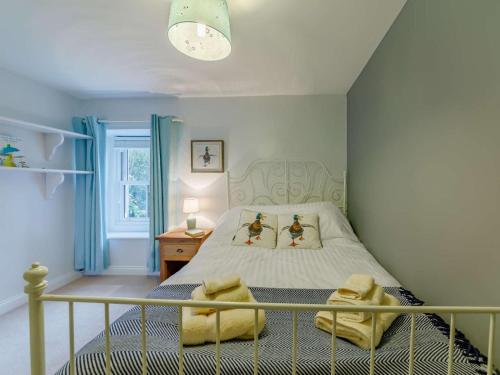 a bedroom with a bed with two duck pillows at 4 Bed in Hexham oc-90521 in Bardon Mill