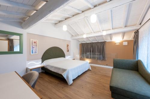 a hotel room with a bed and a couch at La Vecchia cantina Guzzardi in Lari