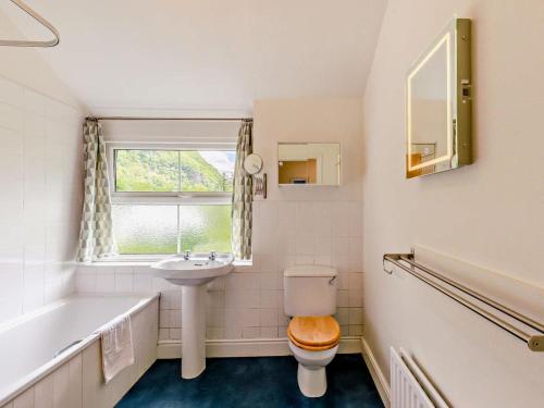 a bathroom with a toilet and a sink and a tub at 3 Bed in Keswick oc-sz148 in Grange