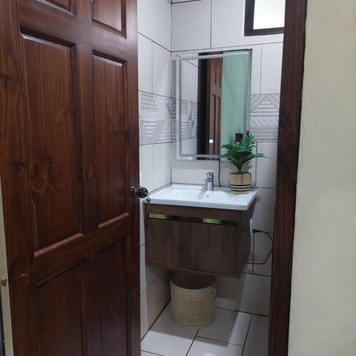 a bathroom with a sink and a mirror at Green Trails Miravalles in Bagaces