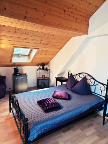 a bedroom with a bed with two pillows on it at Café des Voyageurs Noës in Chalais