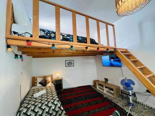 a bedroom with a bunk bed with a loft at Art studio 1 in El Jadida