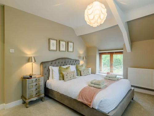 a bedroom with a large bed and a chandelier at 1 Bed in Wareham oc-88099 in Wool