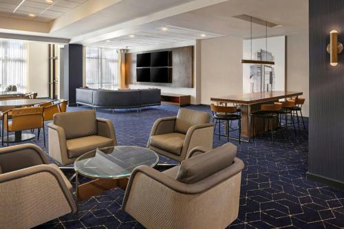 a hotel lobby with chairs and a table and a couch at Courtyard by Marriott Sacramento Midtown in Sacramento