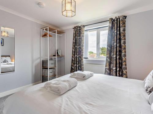 a bedroom with a large white bed with towels on it at 2 Bed in Freshwater oc-94561 in Freshwater