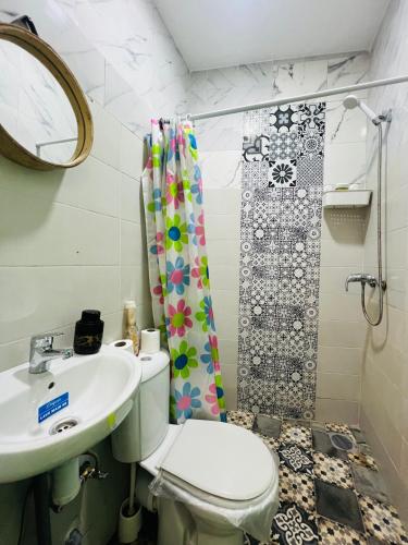 a bathroom with a toilet and a sink and a shower at Art studio 1 in El Jadida