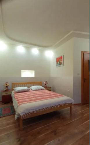 a bedroom with a large bed in a room at Затишні Апартаменти Берегове in Berehove