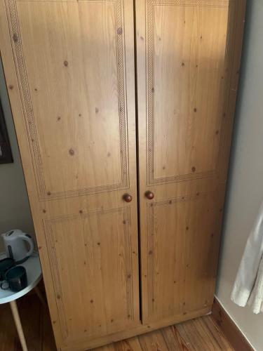 a wooden cabinet in a corner of a room at Ríocht Fódla 3 in Killarney