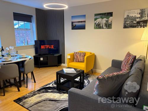 a living room with a couch and a table at restaway at Hamilton in Doncaster