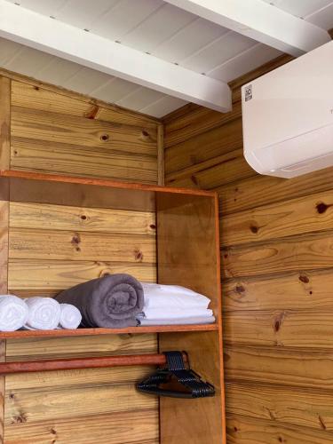 a sauna with towels on a wooden wall at Conforto na praia 2 Quartos com Ar Até 6 Pessoas in Imbituba