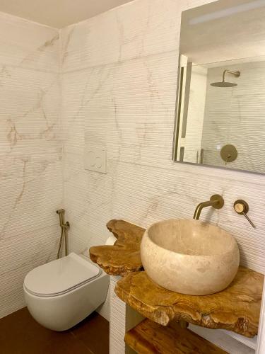 a bathroom with a sink and a toilet at Porta Blu Apulia in Martina Franca