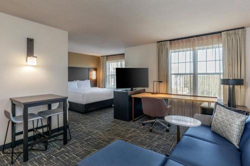 a hotel room with a bed and a desk at Residence Inn Worcester in Worcester