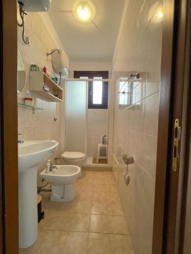 a bathroom with a sink and a toilet and a shower at Solemar Salento in Marittima
