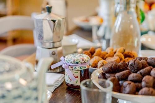 a table with a bunch of donuts and a plate of donuts at La Locanda di Diogene in Case Reggiani