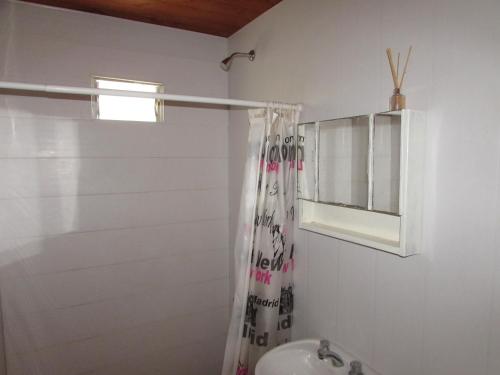 a bathroom with a shower curtain and a sink at Complejo Kallpa in Santiago del Estero