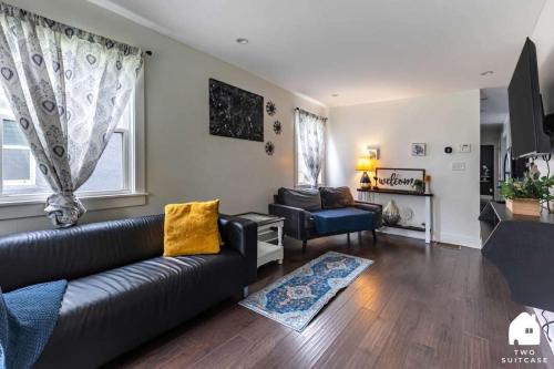 a living room with a couch and a chair at City-Center 2BR Near Attractions in Indianapolis
