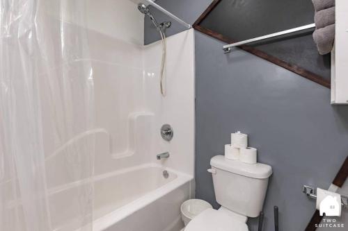 a white bathroom with a toilet and a shower at City-Center 2BR Near Attractions in Indianapolis