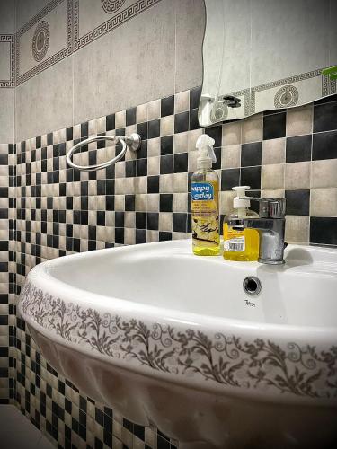 a bathroom sink with a bottle of soap on it at Tayri Surf House Aourir in Agadir
