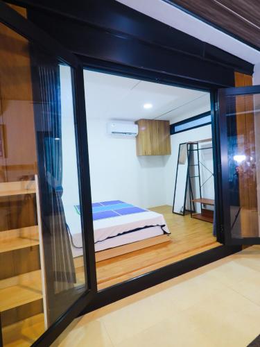 a room with a window with a bed in it at Pickle n Pod villa in Solo with pickle court near mall in Grogol