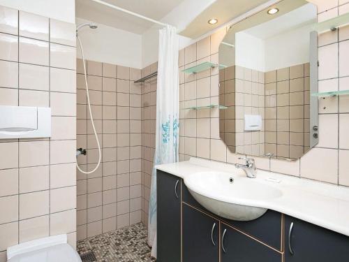 a bathroom with a sink and a mirror at 4 person holiday home on a holiday park in Ringkøbing