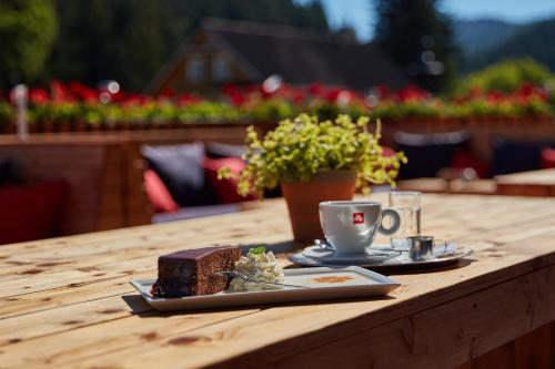 a table with a plate of cake and a cup of coffee at Kovárna Residence in Pec pod Sněžkou