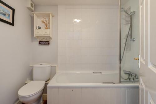 a white bathroom with a toilet and a shower at 1 Bed in Queen Camel oc-c30506 in Queen Camel