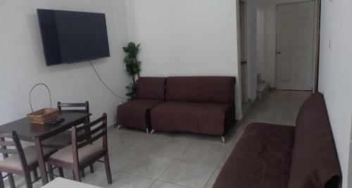 a living room with a couch and a table at Spacious house near the beach in Mazatlán
