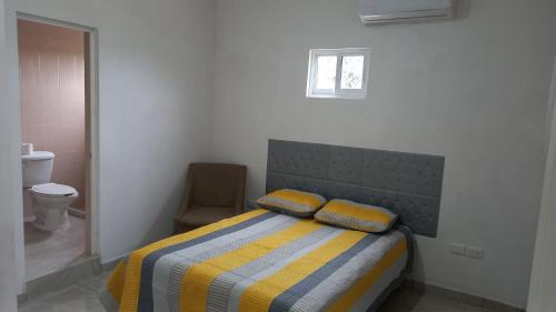 a bedroom with a bed with two pillows on it at Spacious house near the beach in Mazatlán