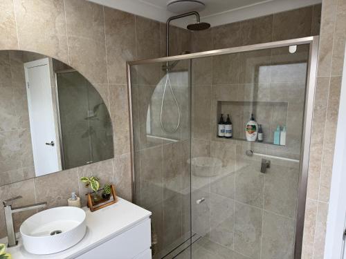 a bathroom with a shower and a sink at SAND Haus in North Haven