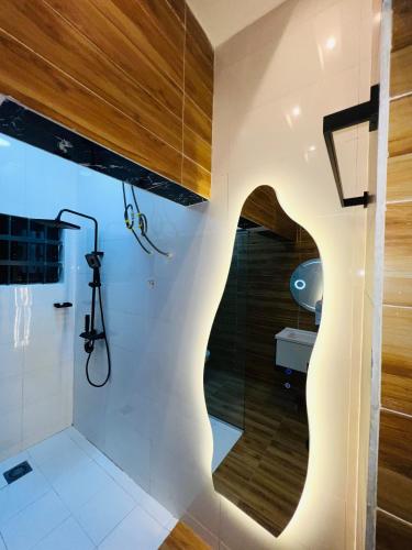 a bathroom with a shower and a glass wall at Best place appartement in Cotonou