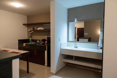 a bathroom with a sink and a large mirror at Casa Rosales in Los Mochis