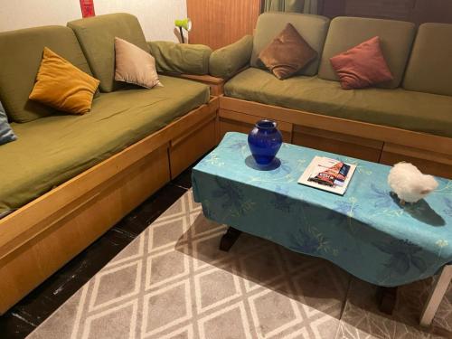 a living room with a couch and a table at Mandala in Vars