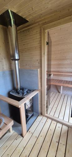 a inside of a sauna with a stove in it at Two Peas in a Pod in Holyhead