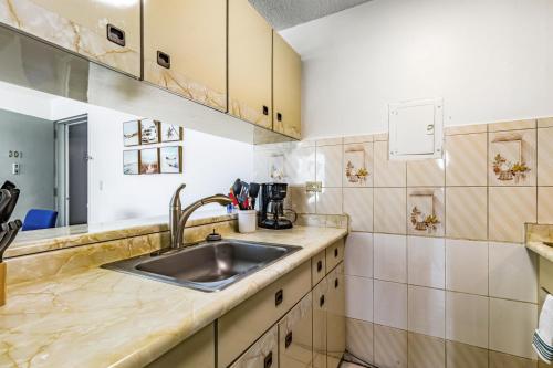 a kitchen with a sink and a counter at Stylish Beach Condo ,1BR , City View Escape in San Juan