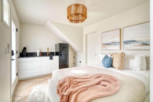 a bedroom with a bed with a blanket on it at Stay Portland - Alberta Arts District Studio Suite in Portland