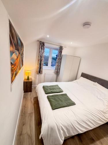 a bedroom with a white bed and a window at Bright Cozy 2 bedroom Apartment in Oxford in Oxford