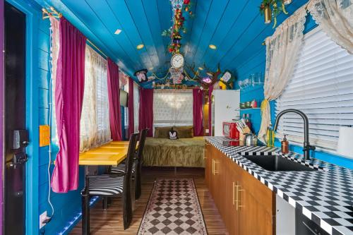 a kitchen with a blue ceiling and a table and chairs at Stay Portland - Mississippi Micro-Luxe - Mid-Century Style in Piedmont