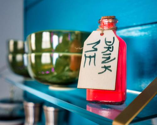 a red bottle with writing on it sitting on a shelf at Stay Portland - Mississippi Micro-Luxe - Mid-Century Style in Piedmont