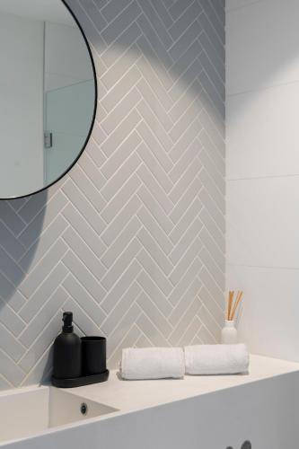 a bathroom with a sink and a mirror at Skyline City Apartment with Pool & Gym & Sauna in Melbourne