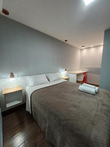 a bedroom with a large bed with two white pillows at Riviera Sanary 1206 - Nova Almeida in Serra