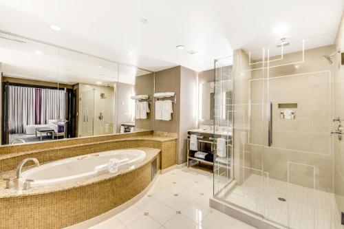 a large bathroom with a tub and a shower at Harrah's Resort Atlantic City, A Caesars Destination in Atlantic City