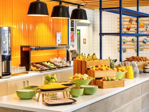 a kitchen with many bowls of fruit on a counter at ibis Budget Terminal 2 Manchester Airport by Accor in Hale