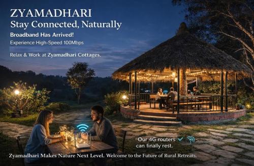a group of people sitting at a table in a gazebo at night at Zyamadhari in Mananthavady